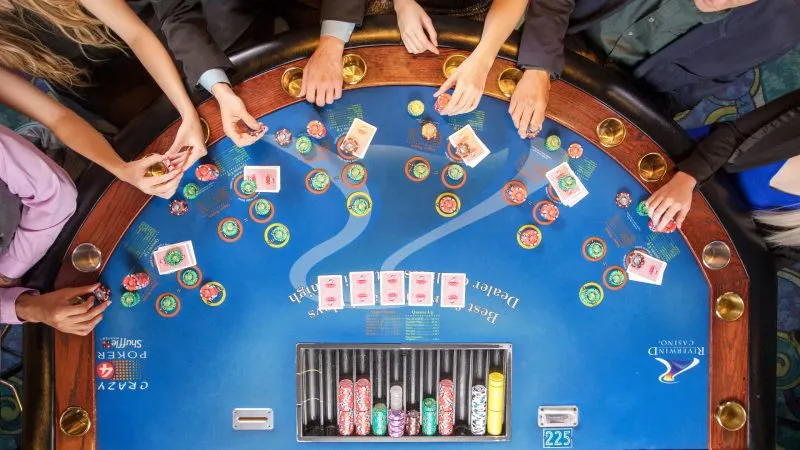 Cheerful Bangladeshi player gesturing toward a shining digital login gateway amid lively casino visuals – representing assured TKHOT re-entry